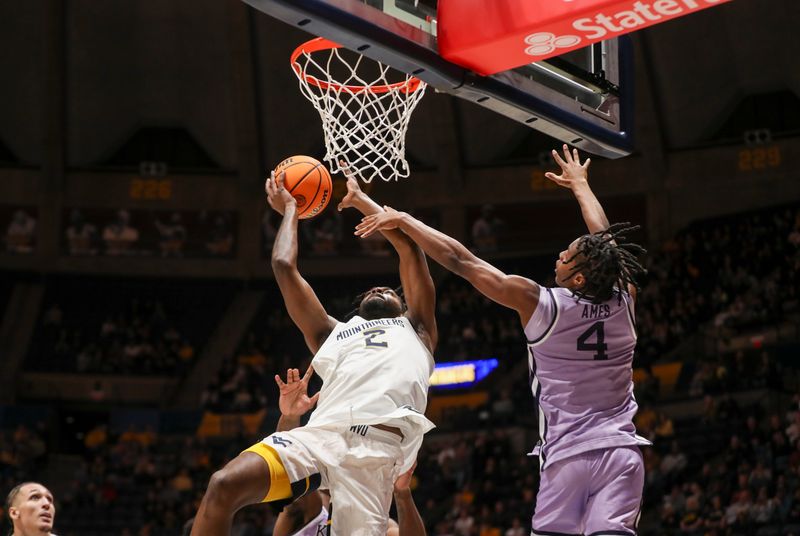 Jan 9, 2024; Morgantown, West Virginia, USA; West Virginia Mountaineers guard Kobe Johnson (2) shoots in the lane against Kansas State Wildcats guard Dai Dai Ames (4) during the second half at WVU Coliseum. Mandatory Credit: Ben Queen-USA TODAY Sports