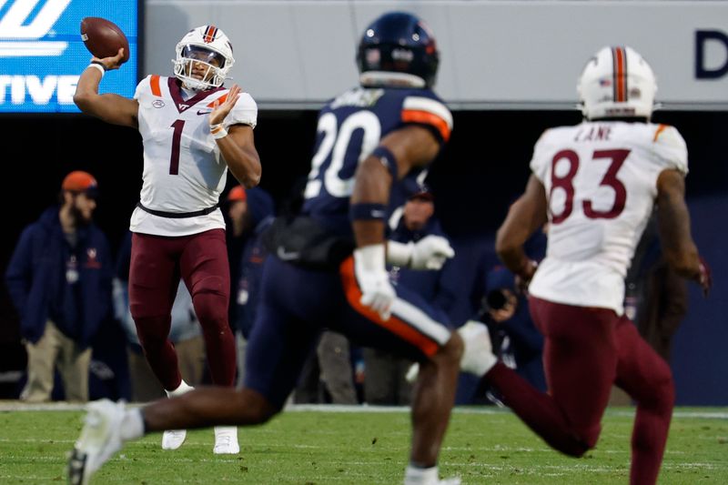 Nov 25, 2023; Charlottesville, Virginia, USA; Virginia Tech Hokies quarterback Kyron Drones (1) passes the ball to Hokies wide receiver Jaylin Lane (83) as Virginia Cavaliers safety Jonas Sanker (20) defends during the second quarter at Scott Stadium. Mandatory Credit: Geoff Burke-USA TODAY Sports