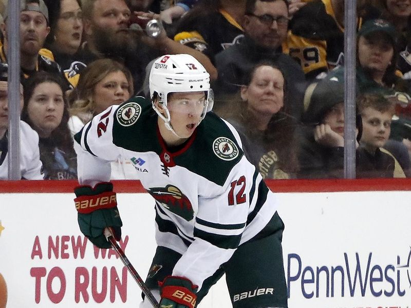 Apr 6, 2023; Pittsburgh, Pennsylvania, USA; Minnesota Wild left wing Matt Boldy (12) handles the puck against the Pittsburgh Penguins during the third period at PPG Paints Arena. Pittsburgh won 4-1. Mandatory Credit: Charles LeClaire-USA TODAY Sports