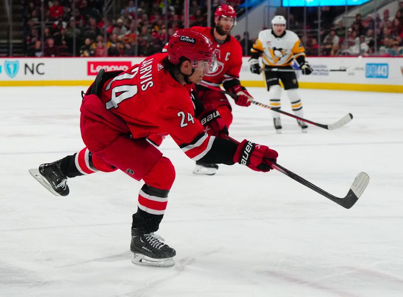 Jan 13, 2024; Raleigh, North Carolina, USA;  Carolina Hurricanes center Seth Jarvis (24) takes a shot against the Pittsburgh Penguins during the third period at PNC Arena. Mandatory Credit: James Guillory-USA TODAY Sports