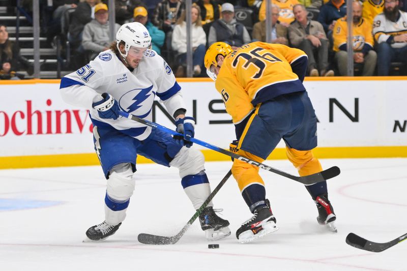 Oct 28, 2025; Nashville, Tennessee, USA;  Nashville Predators left wing Cole Smith (36) and Tampa Bay Lightning defenseman Charle-Edouard D'Astous (51) battle for the puck during the second period at Bridgestone Arena. Mandatory Credit: Steve Roberts-Imagn Images