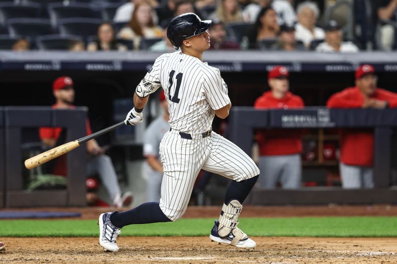 Jul 3, 2024; Bronx, New York, USA; New York Yankees shortstop Anthony Volpe (11) hits a two run double in the seventh inning against the Cincinnati Reds at Yankee Stadium. Mandatory Credit: Wendell Cruz-USA TODAY Sports