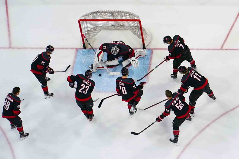 Nov 22, 2023; Raleigh, North Carolina, USA; Carolina Hurricanes goaltender Pyotr Kochetkov (52) warmups against his Hurricanes players before the game against the Edmonton Oilers at PNC Arena. Mandatory Credit: James Guillory-USA TODAY Sports