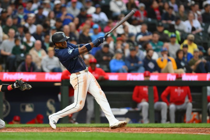 Jul 22, 2024; Seattle, Washington, USA; Seattle Mariners center fielder Victor Robles (10) hits a single against the Los Angeles Angels during the sixth inning at T-Mobile Park. Mandatory Credit: Steven Bisig-USA TODAY Sports