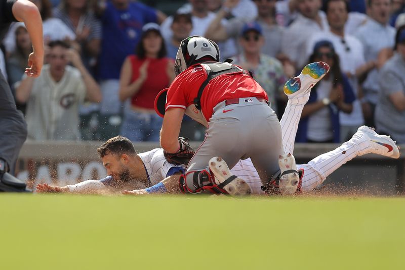 May 31, 2024; Chicago, Illinois, USA; Cincinnati Reds catcher Tyler Stephenson (37) tags out Chicago Cubs third baseman Nick Madrigal (1) as he slides into home plate
during the ninth inning at Wrigley Field. Mandatory Credit: Melissa Tamez-USA TODAY Sports