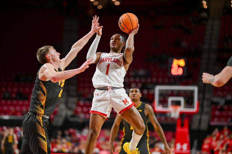 Feb 14, 2024; College Park, Maryland, USA;  Maryland Terrapins guard Jahmir Young (1) shoots as Iowa Hawkeyes guard Josh Dix (4) defends during the second half at Xfinity Center. Mandatory Credit: Tommy Gilligan-USA TODAY Sports