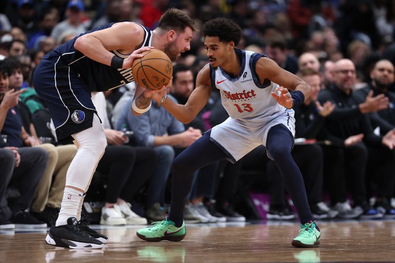 WASHINGTON, DC - DECEMBER 05: Luka Doncic #77 of the Dallas Mavericks is guarded by Jordan Poole #13 of the Washington Wizards during the first half at Capital One Arena on December 05, 2024 in Washington, DC. NOTE TO USER: User expressly acknowledges and agrees that, by downloading and or using this photograph, User is consenting to the terms and conditions of the Getty Images License Agreement. (Photo by Patrick Smith/Getty Images)