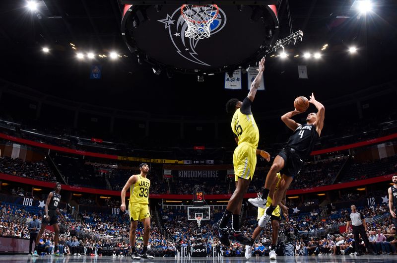 ORLANDO, FL - MARCH 9: Jalen Suggs #4 of the Orlando Magic shoots the ball during the game against the Utah Jazz on March 9, 2023 at Amway Center in Orlando, Florida. NOTE TO USER: User expressly acknowledges and agrees that, by downloading and or using this photograph, User is consenting to the terms and conditions of the Getty Images License Agreement. Mandatory Copyright Notice: Copyright 2023 NBAE (Photo by Fernando Medina/NBAE via Getty Images)