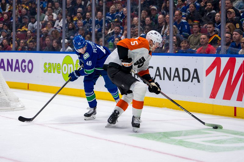 Oct 11, 2024; Vancouver, British Columbia, CAN; Vancouver Canucks forward Elias Pettersson (40) defends against Philadelphia Flyers defenseman Egor Zamula (5) during the first period at Rogers Arena. Mandatory Credit: Bob Frid-Imagn Images