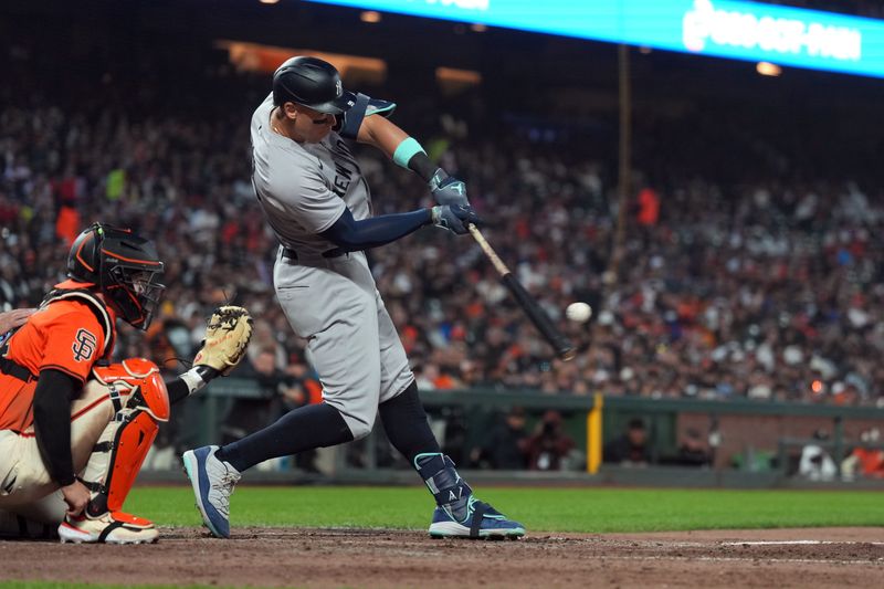 May 31, 2024; San Francisco, California, USA; New York Yankees designated hitter Aaron Judge (center) hits a home run against the San Francisco Giants during the sixth inning at Oracle Park. Mandatory Credit: Darren Yamashita-USA TODAY Sports