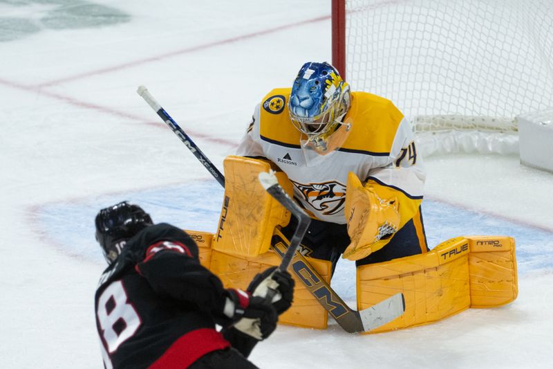 Oct 13, 2025; Ottawa, Ontario, CAN; Ottawa Senators center Tim Stutzle (18) shoots on Nashville Predators goalie Juuse Saros (74) in the third period at the Canadian Tire Centre. Mandatory Credit: Marc DesRosiers-IMAGN Images