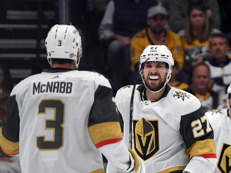 Mar 26, 2024; Nashville, Tennessee, USA; Vegas Golden Knights defenseman Shea Theodore (27) celebrates with defenseman Brayden McNabb (3) after a goal during the first period against the Nashville Predators at Bridgestone Arena. Mandatory Credit: Christopher Hanewinckel-USA TODAY Sports