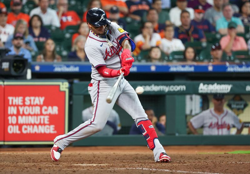 Apr 17, 2024; Houston, Texas, USA; Atlanta Braves shortstop Orlando Arcia (11) hits a RBI single against the Houston Astros in the10th inning at Minute Maid Park. Mandatory Credit: Thomas Shea-USA TODAY Sports