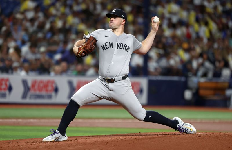 Jul 9, 2024; St. Petersburg, Florida, USA;  New York Yankees starting pitcher Carlos Rodon (55) throws a pitch against the Tampa Bay Rays during the first inning at Tropicana Field. Mandatory Credit: Kim Klement Neitzel-USA TODAY Sports