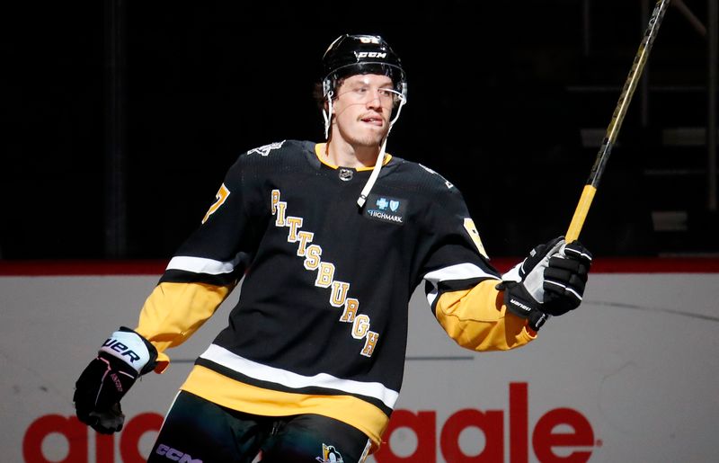 Apr 6, 2023; Pittsburgh, Pennsylvania, USA; Pittsburgh Penguins right wing Rickard Rakell (67) reacts after being named a star of the game and defeating the Minnesota Wild at PPG Paints Arena. Pittsburgh won 4-1. Mandatory Credit: Charles LeClaire-USA TODAY Sports