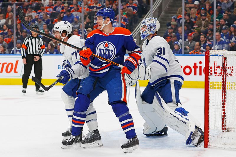 Jan 16, 2024; Edmonton, Alberta, CAN; Edmonton Oilers forward Zach Hyman (18) battles with Toronto Maple Leafs defensemen T.J. Brodie (78) in front of goaltender Martin Jones (31) during the third period at Rogers Place. Mandatory Credit: Perry Nelson-USA TODAY Sports