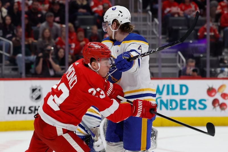 Apr 7, 2024; Detroit, Michigan, USA; Detroit Red Wings left wing Lucas Raymond (23) and Buffalo Sabres defenseman Bowen Byram (4) fight for position in the second period at Little Caesars Arena. Mandatory Credit: Rick Osentoski-USA TODAY Sports