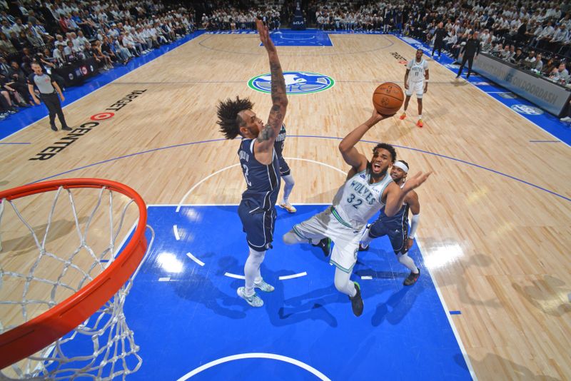 MINNEAPOLIS, MN - MAY 22: Karl-Anthony Towns #32 of the Minnesota Timberwolves shoots the ball during the game against the Dallas Mavericks during Game 1 of the Western Conference Finals of the 2024 NBA Playoffs on May 22, 2024 at Target Center in Minneapolis, Minnesota. NOTE TO USER: User expressly acknowledges and agrees that, by downloading and or using this Photograph, user is consenting to the terms and conditions of the Getty Images License Agreement. Mandatory Copyright Notice: Copyright 2024 NBAE (Photo by Jesse D. Garrabrant/NBAE via Getty Images)