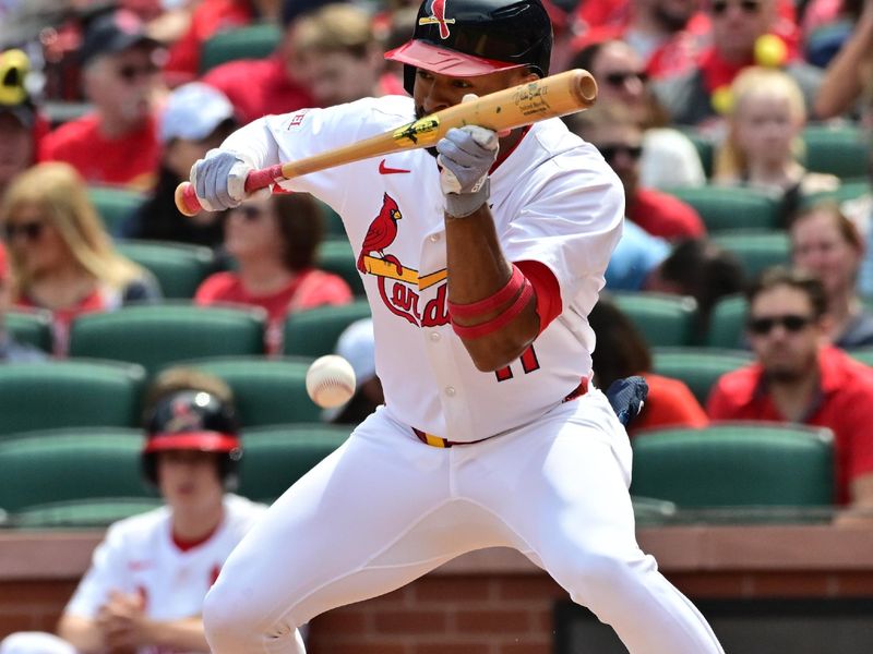 Apr 13, 2025; St. Louis, Missouri, USA; St. Louis Cardinals outfielder Victor Scott II (11) bunts in the third inning against the Philadelphia Phillies at Busch Stadium. Mandatory Credit: Tim Vizer-Imagn Images