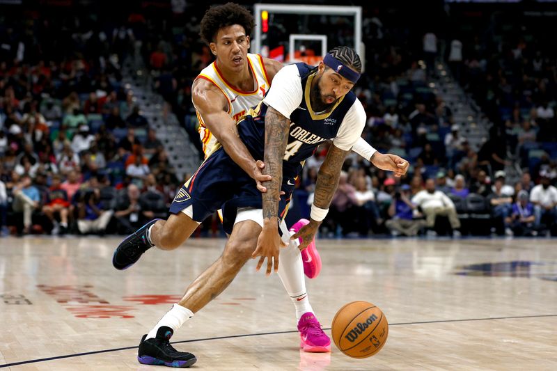 NEW ORLEANS, LOUISIANA - NOVEMBER 03: Brandon Ingram #14 of the New Orleans Pelicans drives past Jalen Johnson #1 of the Atlanta Hawks during the fourth quarter at Smoothie King Center on November 03, 2024 in New Orleans, Louisiana. NOTE TO USER: User expressly acknowledges and agrees that, by downloading and or using this photograph, User is consenting to the terms and conditions of the Getty Images License Agreement. (Photo by Sean Gardner/Getty Images)