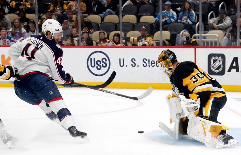 Oct 4, 2024; Pittsburgh, Pennsylvania, USA;  Pittsburgh Penguins goaltender Joel Blomqvist (30) makes a save against Columbus Blue Jackets forward Hunter McKowan (41) during the second period at PPG Paints Arena. Mandatory Credit: Charles LeClaire-Imagn Images