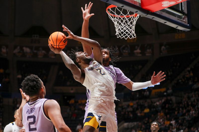 Jan 9, 2024; Morgantown, West Virginia, USA; West Virginia Mountaineers guard Kobe Johnson (2) shoots against Kansas State Wildcats forward Will McNair Jr. (13) during the second half at WVU Coliseum. Mandatory Credit: Ben Queen-USA TODAY Sports