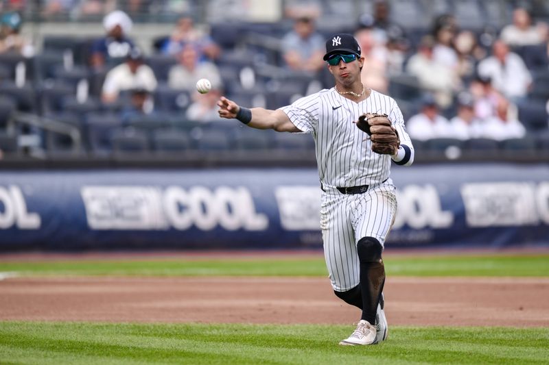 Aug 22, 2024; Bronx, New York, USA; New York Yankees third baseman Oswaldo Cabrera (95) fields a ground ball and throws to first base for an out against the Cleveland Guardians during the fourth inning at Yankee Stadium. Mandatory Credit: John Jones-USA TODAY Sports