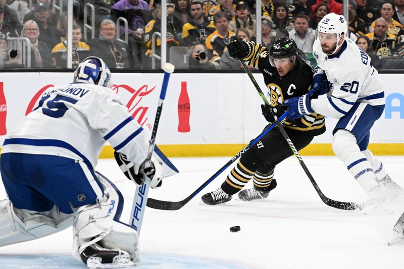 Apr 22, 2024; Boston, Massachusetts, USA; Boston Bruins left wing Brad Marchand (63) and Toronto Maple Leafs defenseman Joel Edmundson (20) battle for the puck in front of goaltender Ilya Samsonov (35) during the first period in game two of the first round of the 2024 Stanley Cup Playoffs at TD Garden. Mandatory Credit: Brian Fluharty-USA TODAY Sports