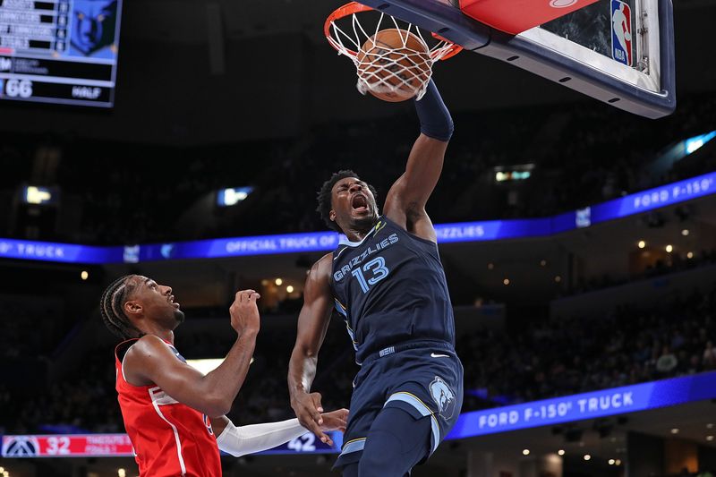 MEMPHIS, TENNESSEE - NOVEMBER 08: Jaren Jackson Jr. #13 of the Memphis Grizzlies goes to the basket against Alexandre Sarr #20 of the Washington Wizards during the first half at FedExForum on November 08, 2024 in Memphis, Tennessee. NOTE TO USER: User expressly acknowledges and agrees that, by downloading and or using this photograph, User is consenting to the terms and conditions of the Getty Images License Agreement. (Photo by Justin Ford/Getty Images)