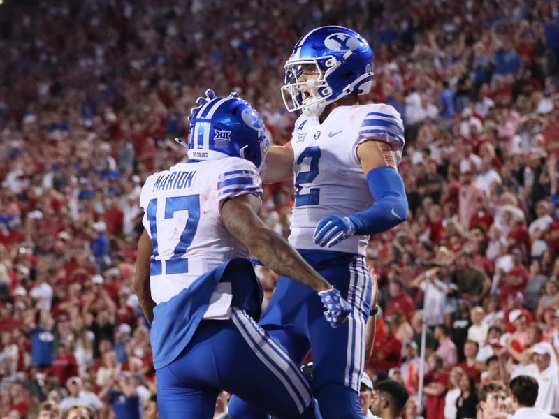 Sep 16, 2023; Fayetteville, Arkansas, USA; BYU Cougars wide receiver Chase Roberts (2) celebrates with wide receiver Keelan Marion (17) after catching a pass for a touchdown in the fourth quarter against the Arkansas Razorbacks at Donald W. Reynolds Razorback Stadium. BYU won 38-31. Mandatory Credit: Nelson Chenault-USA TODAY Sports