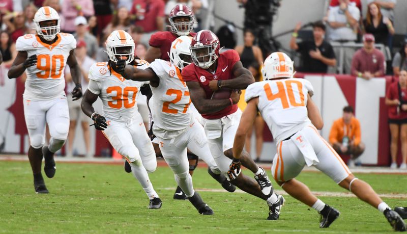 Oct 21, 2023; Tuscaloosa, Alabama, USA;  Tennessee Volunteers defensive lineman James Pearce Jr. (27) and Tennessee Volunteers linebacker Kalib Perry (40) close in to tackle Alabama Crimson Tide quarterback Jalen Milroe (4) at Bryant-Denny Stadium. Alabama defeated Tennessee 34-20. Mandatory Credit: Gary Cosby Jr.-USA TODAY Sports