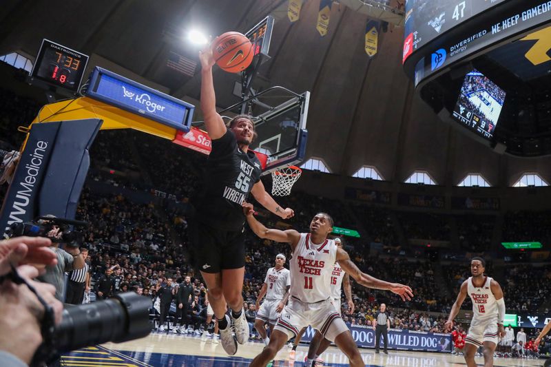 Feb 8, 2026; Morgantown, West Virginia, USA; West Virginia Mountaineers center Harlan Obioha (55) dives to save a ball from going out of bounds during the second half against the Texas Tech Red Raiders at Hope Coliseum. Mandatory Credit: Ben Queen-Imagn Images