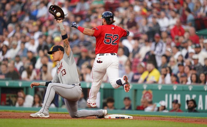 May 31, 2024; Boston, Massachusetts, USA; Boston Red Sox right fielder Wilyer Abreu (52) out at first base by Detroit Tigers first baseman Gio Urshela (13) in the first inning at Fenway Park. Mandatory Credit: David Butler II-USA TODAY Sports