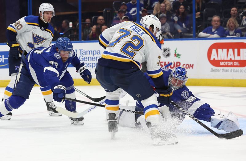 Dec 19, 2023; Tampa, Florida, USA; Tampa Bay Lightning goaltender Andrei Vasilevskiy (88) makes a save against St. Louis Blues defenseman Justin Faulk (72) during the second period at Amalie Arena. Mandatory Credit: Kim Klement Neitzel-USA TODAY Sports