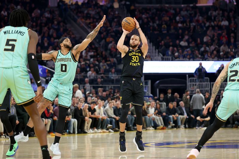 SAN FRANCISCO, CALIFORNIA - FEBRUARY 25: Stephen Curry #30 of the Golden State Warriors shoots over Miles Bridges #0 of the Charlotte Hornets during the first half at Chase Center on February 25, 2025 in San Francisco, California. NOTE TO USER: User expressly acknowledges and agrees that, by downloading and/or using this photograph, user is consenting to the terms and conditions of the Getty Images License Agreement.   (Photo by Ezra Shaw/Getty Images)