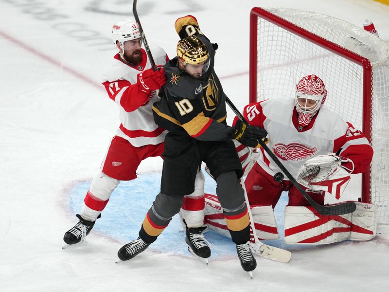 Jan 19, 2023; Las Vegas, Nevada, USA; Vegas Golden Knights center Nicolas Roy (10) deflects a shot towards Detroit Red Wings goaltender Ville Husso (35) as defenseman Filip Hronek (17) applies a check during the third period at T-Mobile Arena. Mandatory Credit: Stephen R. Sylvanie-USA TODAY Sports