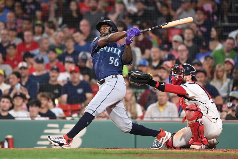 Jul 29, 2024; Boston, Massachusetts, USA; Seattle Mariners left fielder Randy Arozarena (56) hits a home run against the Boston Red Sox during the sixth inning at Fenway Park. Mandatory Credit: Eric Canha-USA TODAY Sports