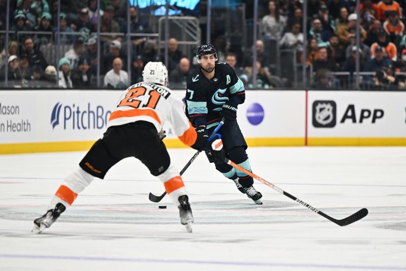 Feb 16, 2023; Seattle, Washington, USA; Seattle Kraken right wing Jordan Eberle (7) advances the puck while being defended by Philadelphia Flyers center Scott Laughton (21) during the first period at Climate Pledge Arena. Mandatory Credit: Steven Bisig-USA TODAY Sports