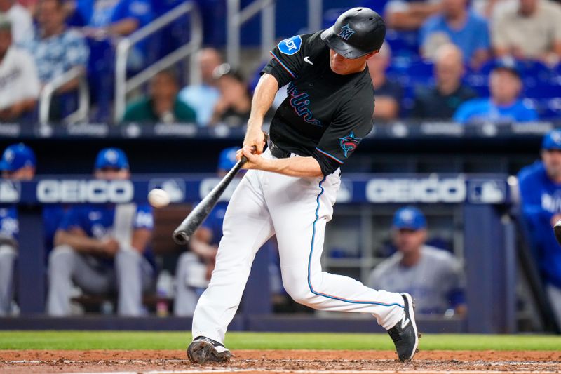 Jun 7, 2023; Miami, Florida, USA; Miami Marlins shortstop Joey Wendle (18) hits a single against the Kansas City Royals during the fourth inning at loanDepot Park. Mandatory Credit: Rich Storry-USA TODAY Sports