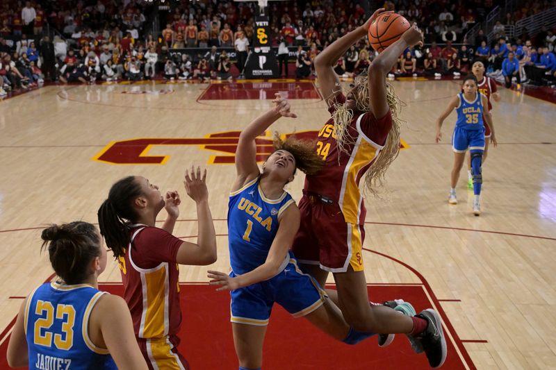 Jan 14, 2024; Los Angeles, California, USA; UCLA Bruins guard Kiki Rice (1) reaches to defend a shot by USC Trojans center Clarice Akunwafo (34) in the second half at Galen Center. Mandatory Credit: Jayne Kamin-Oncea-USA TODAY Sports