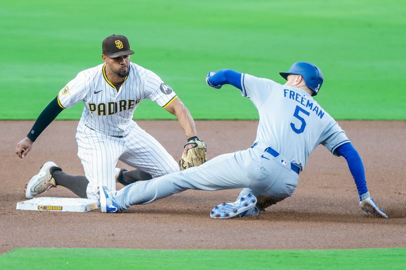 Jun 9, 2025; San Diego, California, USA; Los Angeles Dodgers first baseman Freddie Freeman (5) slides under the tag of San Diego Padres shortstop Xander Bogaerts (2) for a double during the first inning against the San Diego Padres at Petco Park. Mandatory Credit: David Frerker-Imagn Images