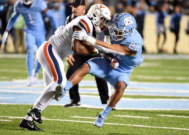 Nov 2, 2019; Chapel Hill, NC, USA; Virginia Cavaliers receiver Hasise Dubois (8) is tackled by North Carolina Tar Heels linebacker Chazz Surratt (21) during the first half at Kenan Memorial Stadium. Mandatory Credit: Rob Kinnan-USA TODAY Sports