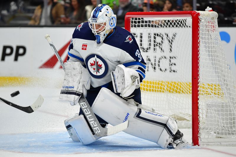 Jan 5, 2024; Anaheim, California, USA; Winnipeg Jets goaltender Laurent Brossoit (39) blocks a shot against the Anaheim Ducks during the second period at Honda Center. Mandatory Credit: Gary A. Vasquez-USA TODAY Sports