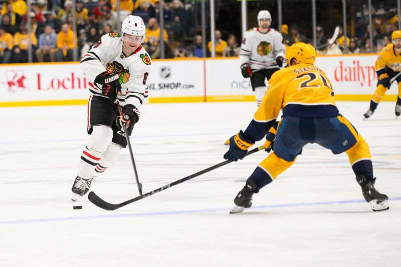 Jan 16, 2025; Nashville, Tennessee, USA;  Chicago Blackhawks center Ryan Donato (8) skates as Nashville Predators defenseman Spencer Stastney (24) defends during the second period at Bridgestone Arena. Mandatory Credit: Steve Roberts-Imagn Images