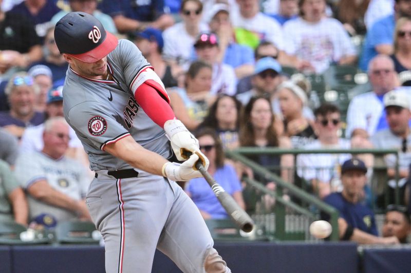 Jul 13, 2024; Milwaukee, Wisconsin, USA; Washington Nationals catcher Riley Adams (15) hits a single to drive in a run in the fourth inning against the Milwaukee Brewers at American Family Field. Mandatory Credit: Benny Sieu-USA TODAY Sports