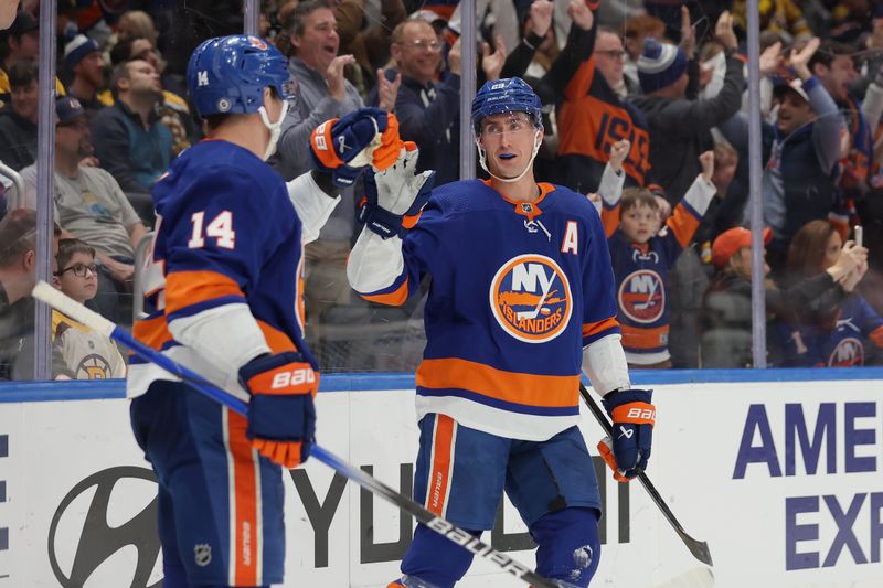 Mar 2, 2024; Elmont, New York, USA; New York Islanders center Brock Nelson (29) celebrates his goal against the Boston Bruins with center Bo Horvat (14) during the second period at UBS Arena. Mandatory Credit: Brad Penner-USA TODAY Sports