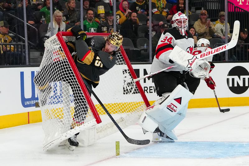 Mar 17, 2024; Las Vegas, Nevada, USA; Vegas Golden Knights defenseman Noah Hanifin (15) skates into the net behind New Jersey Devils goaltender Jake Allen (34) during the third period at T-Mobile Arena. Mandatory Credit: Stephen R. Sylvanie-USA TODAY Sports