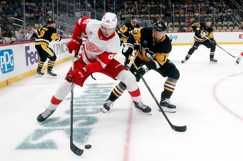 Oct 1, 2024; Pittsburgh, Pennsylvania, USA;  Detroit Red Wings left wing Elmer Soderblom (85) handles the puck against Pittsburgh Penguins right wing Kevin Hayes (13) during the second period at PPG Paints Arena. Mandatory Credit: Charles LeClaire-Imagn Images