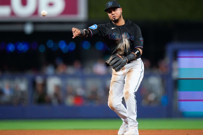 Aug 16, 2023; Miami, Florida, USA; Miami Marlins second baseman Luis Arraez (3) throws the ball to first base for an out against the Houston Astros during the fifth inning at loanDepot Park. Mandatory Credit: Rich Storry-USA TODAY Sports