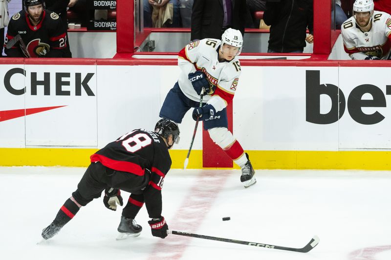 Apr 5, 2025; Ottawa, Ontario, CAN; Florida Panthers center Anton Lundell (15) shoots the puck past Ottawa Senators center Tim Stutzle (18) in the third period at the Canadian Tire Centre. Mandatory Credit: Marc DesRosiers-Imagn Images